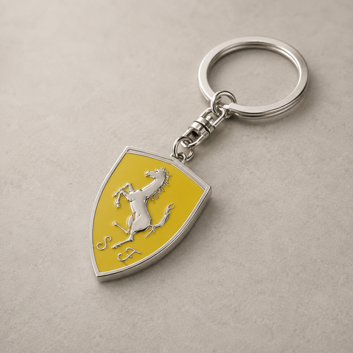 Yellow shield horse emblem keychain on stone background